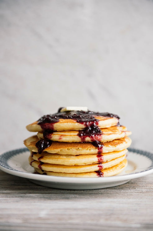 Load image into Gallery viewer, a stack of pancakes topped with fruit compote