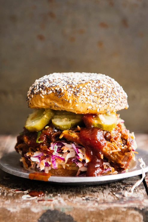 Load image into Gallery viewer, a pulled sauce pork sandwich with bb