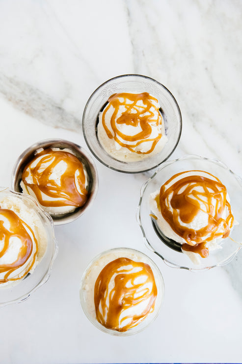 Load image into Gallery viewer, Bowls of ice cream topped with Salted Caramel Sauce
