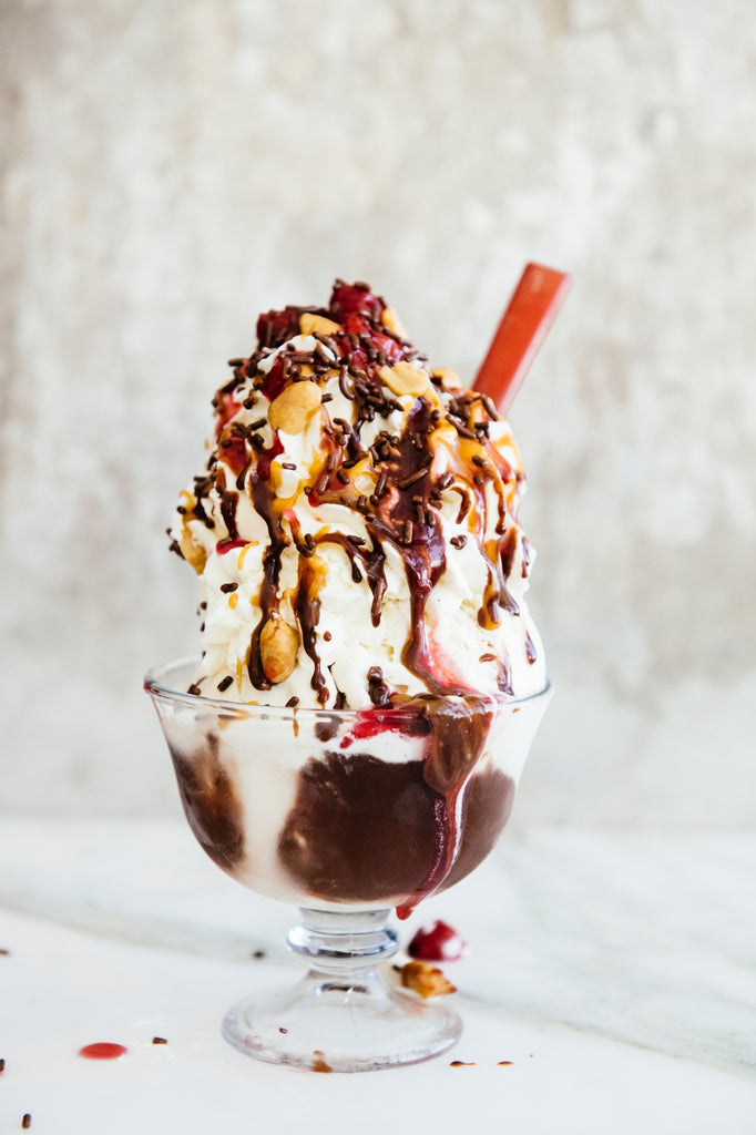 Vanilla ice cream sundae topped with Chocolate Fudge Sauce, Salted Maple Caramel and Sour Cherries