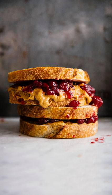 Load image into Gallery viewer, a stack of peanut butter and jam sandwiches