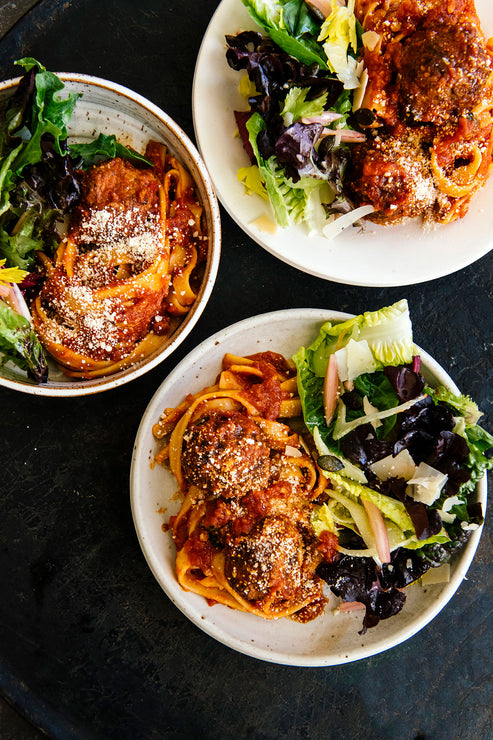 Load image into Gallery viewer, plates of spaghetti and meatballs with a side salad