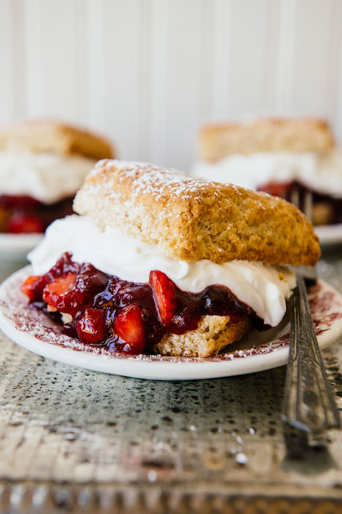 Load image into Gallery viewer, Single homemade biscuit with whipped cream and fresh strawberries in the middle