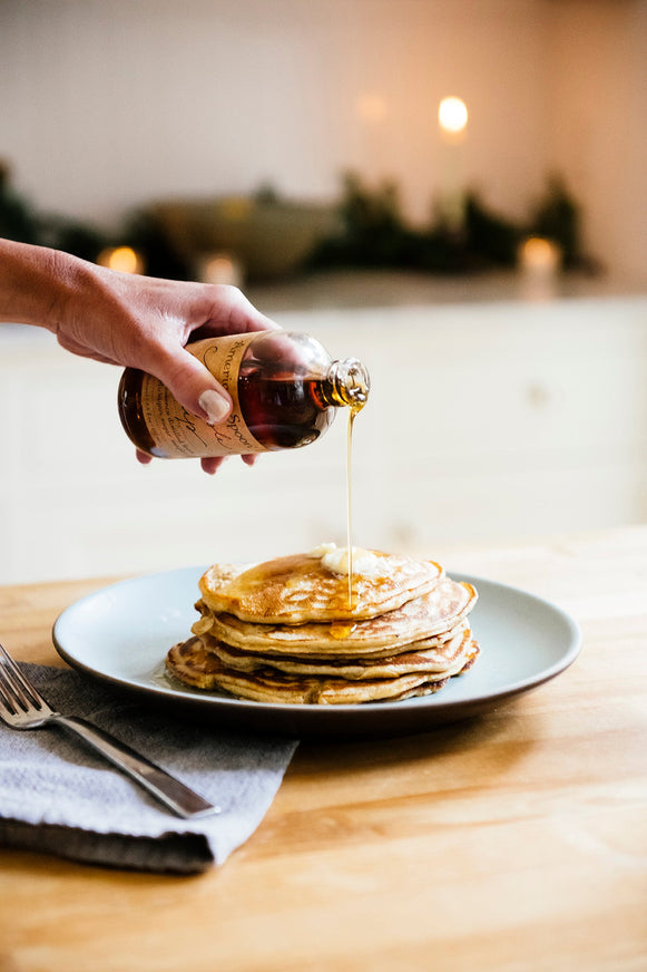Maple Syrup being drizzled over a stack of pancakes