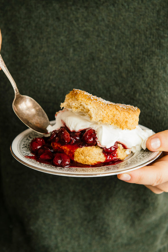 a biscuit filled with homemade whipped cream and cherries