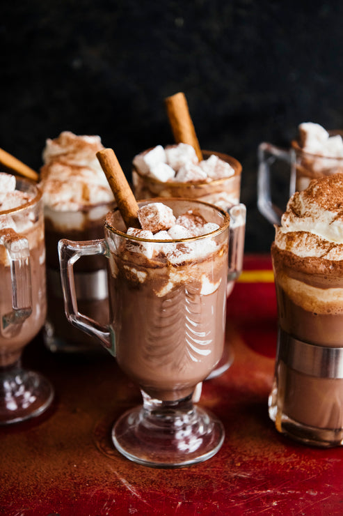 Load image into Gallery viewer, cups of hot cocoa topped with marshmallows and cinnamon sticks