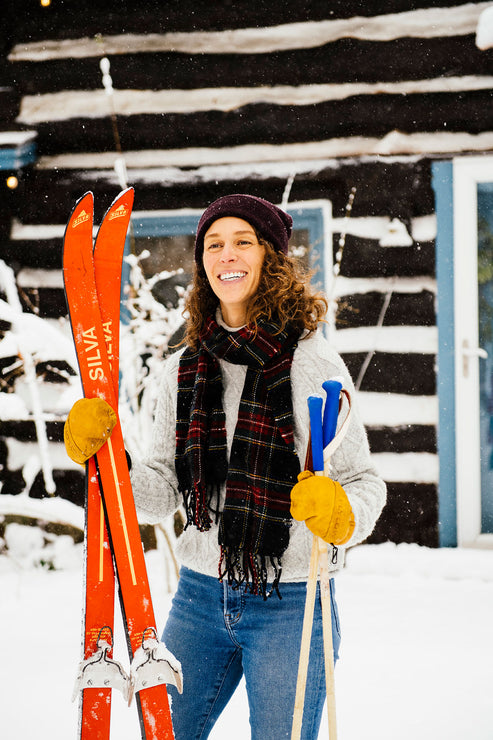 Load image into Gallery viewer, a woman in the snow holding skis