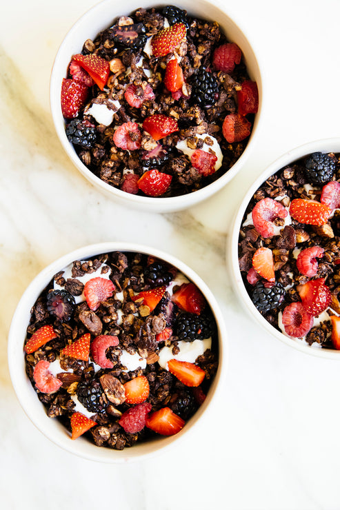 Load image into Gallery viewer, bowls of chocolate granola topped wtih fresh berries