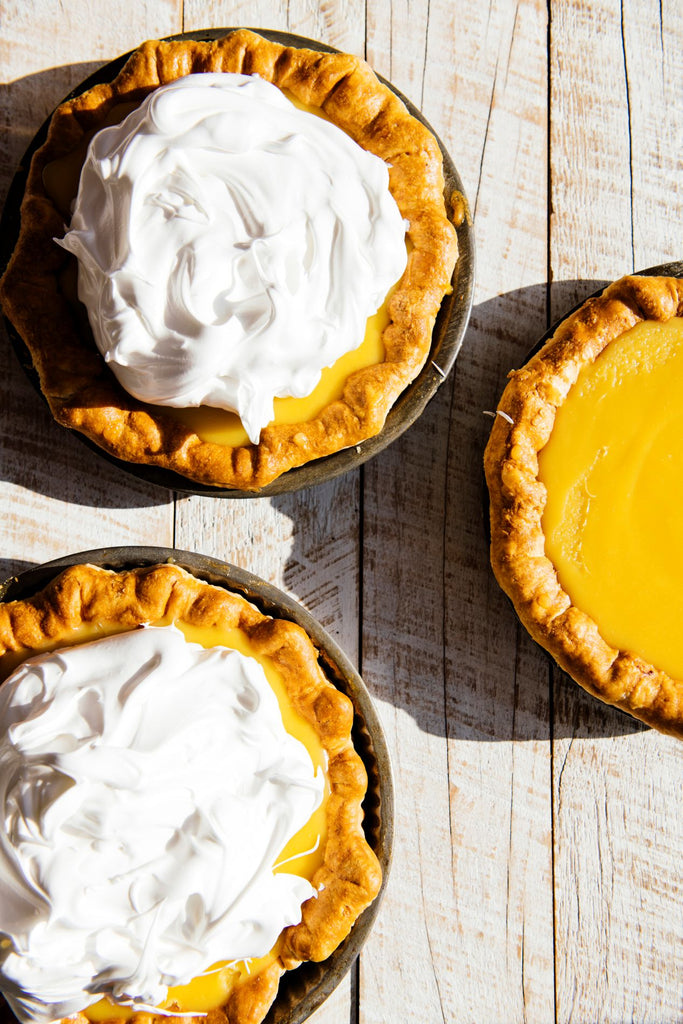 homemade curd tarts topped with fresh whipped cream