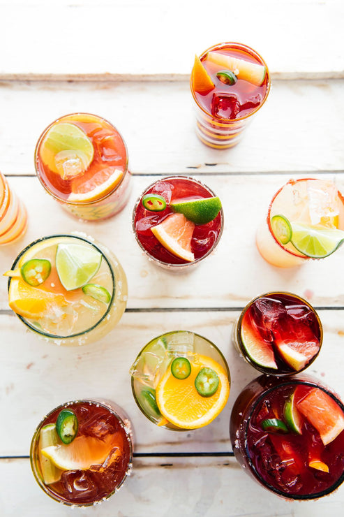 Load image into Gallery viewer, glasses of homemade cocktails with fresh fruit garnishes