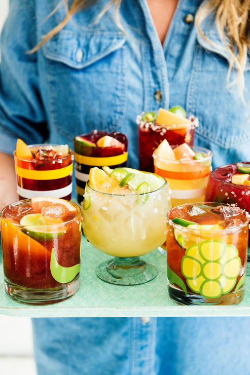 Load image into Gallery viewer, a tray filled with glasses of homemade cocktails with fresh fruit garnishes