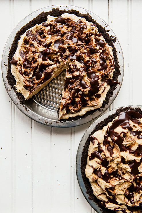 Load image into Gallery viewer, homemade peanut butter and chocolate pies, one with a slice taken out