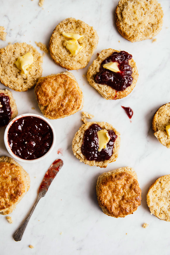 Open face biscuits topped with preserves and butter