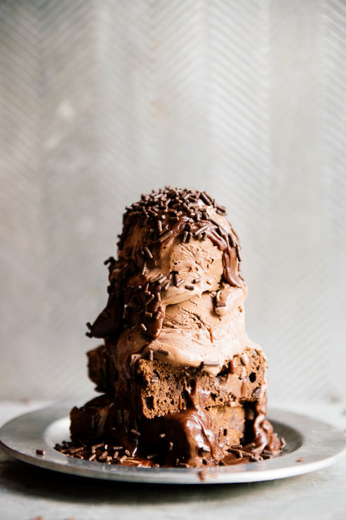 Load image into Gallery viewer, a brownie sundae topped with chocolate fudge sauce and chocolate sprinkles
