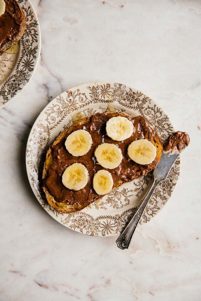 toast topped with chocolate hazelnut butter and sliced bananas
