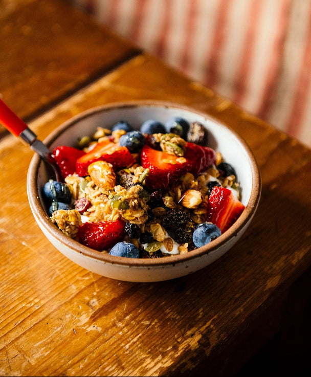 Load image into Gallery viewer, a bowl of granola with fresh berries