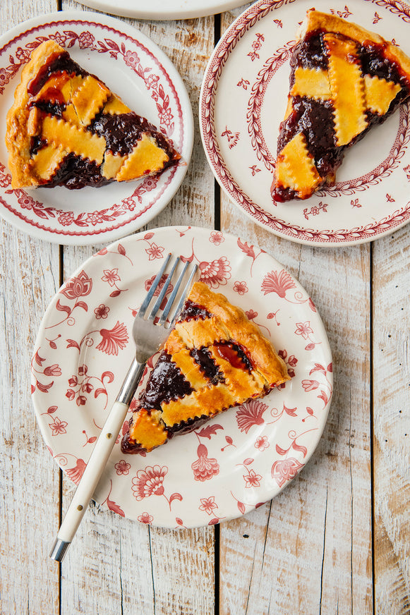 Slices of homemade cherry pie on plates