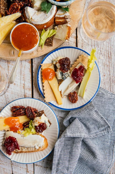Load image into Gallery viewer, a charcuterie tray of cheeses, crackers, olives, candied pecans and various preserves and jams