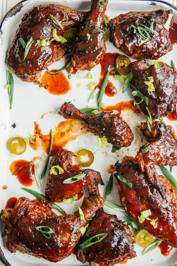 a tray of cherry bbq chicken wings, thighs and drumsticks