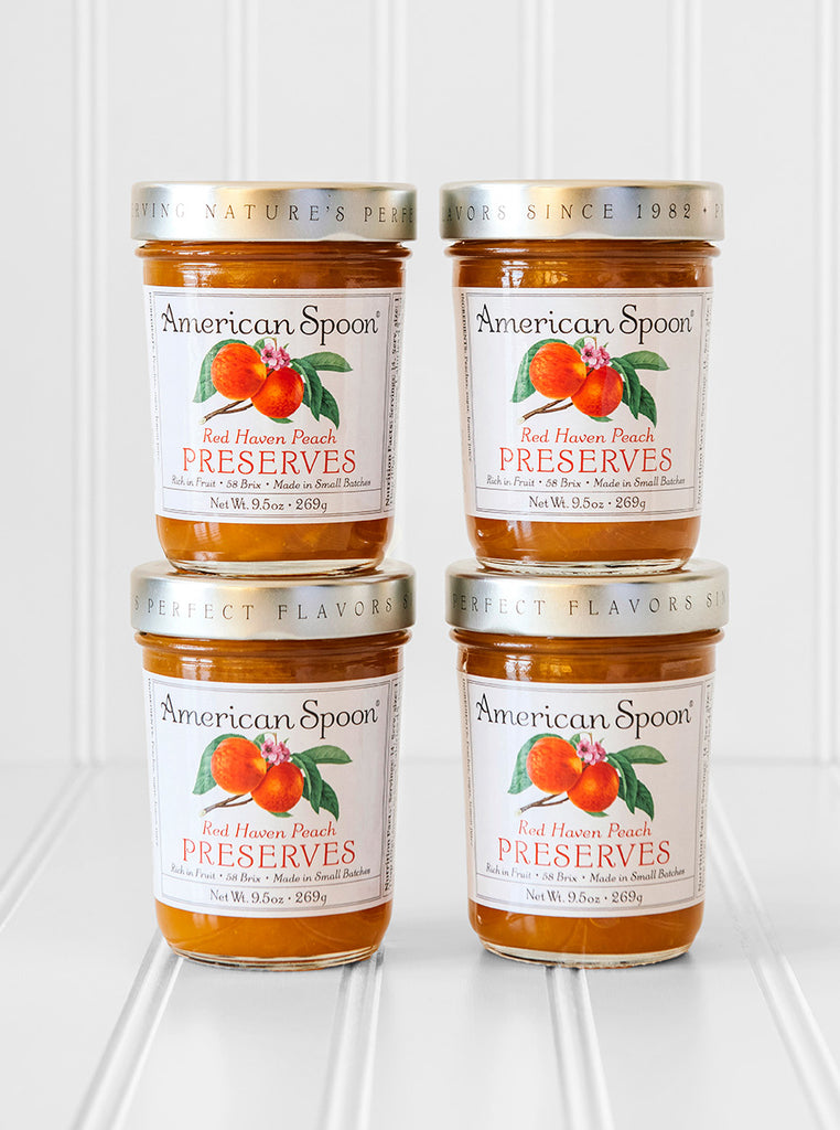 A stack of four jars of Red Haven Peach Preserves