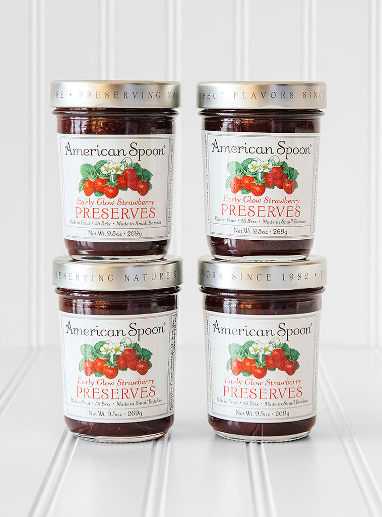A stack of four jars of Early Glow Strawberry Preserves