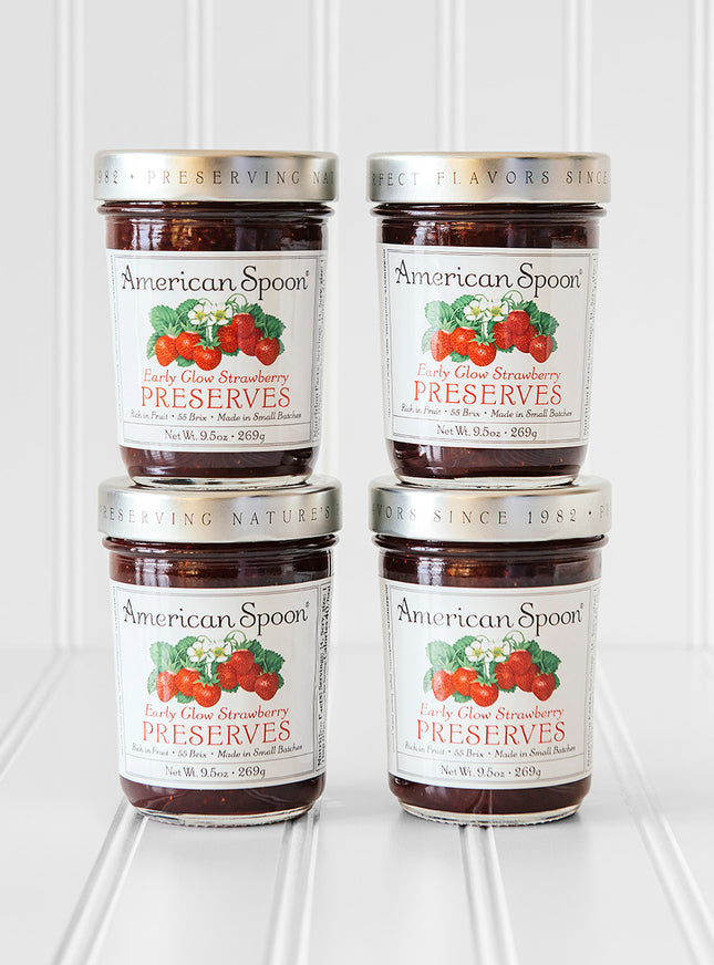 A stack of four jars of Early Glow Strawberry Preserves
