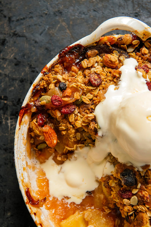 Load image into Gallery viewer, peach gobbler topped with maple granola and fresh vanilla ice cream