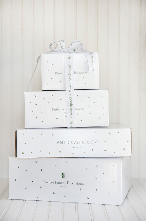 Stack of American Spoon gift boxes wrapped in white ribbon