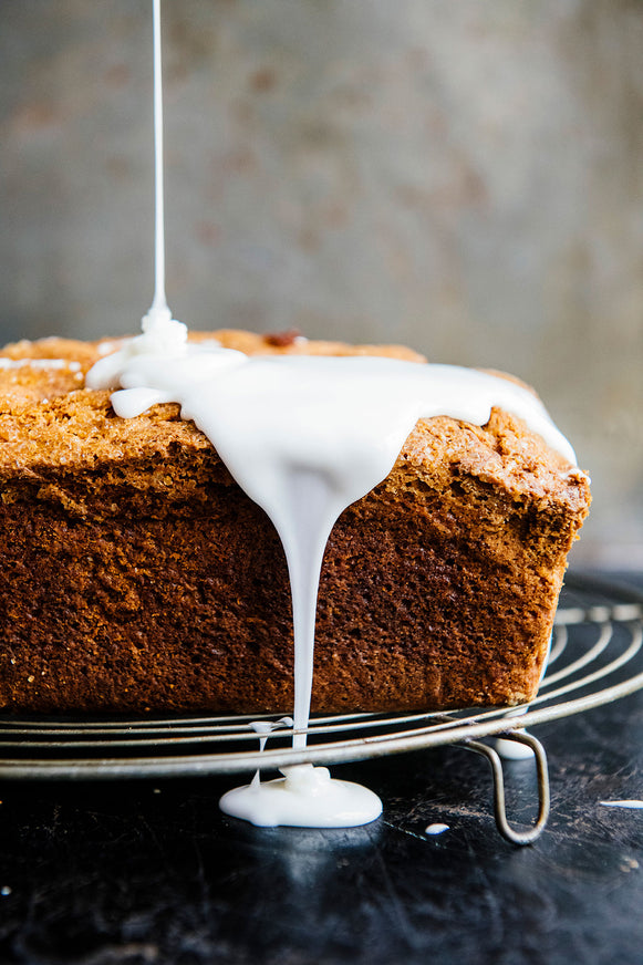 a loaf of pumpkin bread topped with frosting