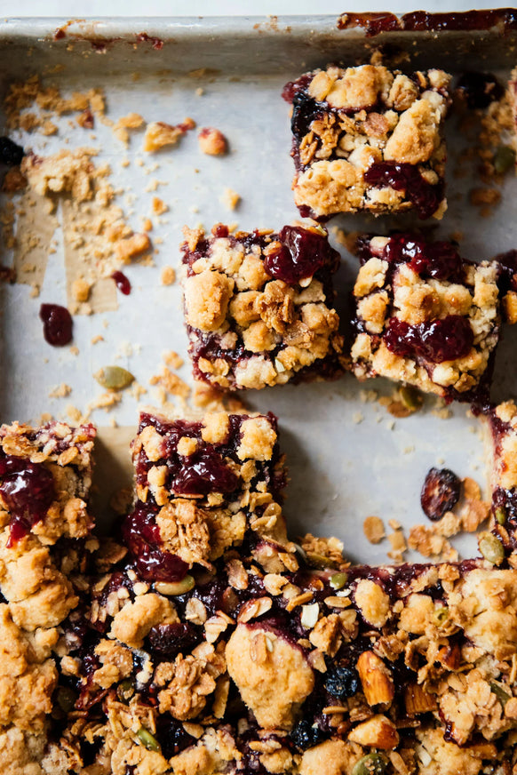 a tray of homemade granola bars with preserves