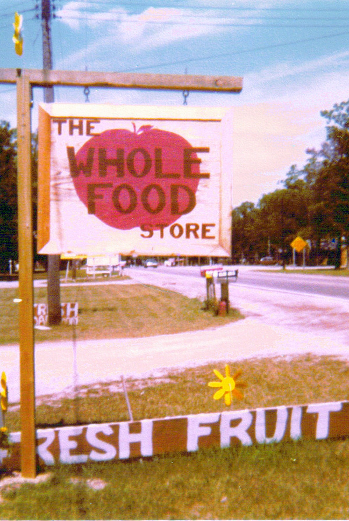 A roadside sign noting The Whole Food Store and Fresh Fruit
