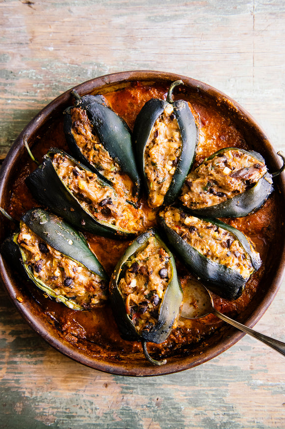 A plate of stuffed poblano peppers