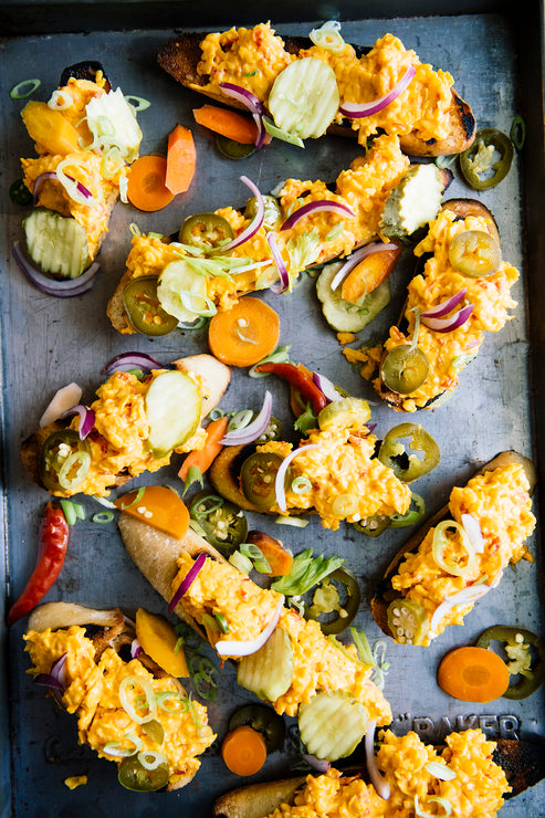 Load image into Gallery viewer, Slices of toast topped with pimento cheese made with Chili Jam, jalapenos and onions