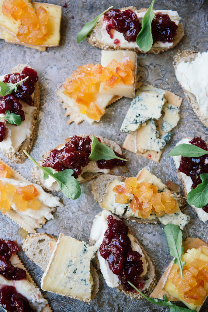 Crackers topped with blue cheese, goat cheese and preserves