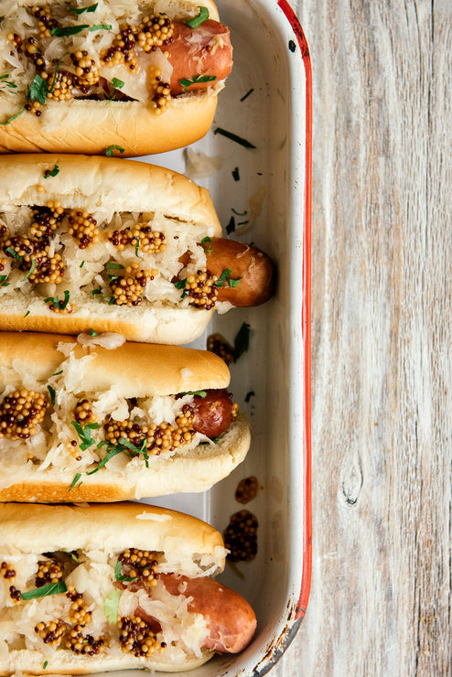 Load image into Gallery viewer, Hot dogs topped with sauerkraut and Whole Seed Mustard
