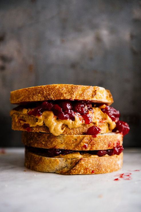 Load image into Gallery viewer, A stack of Peanut Butter and Jelly sandwiches