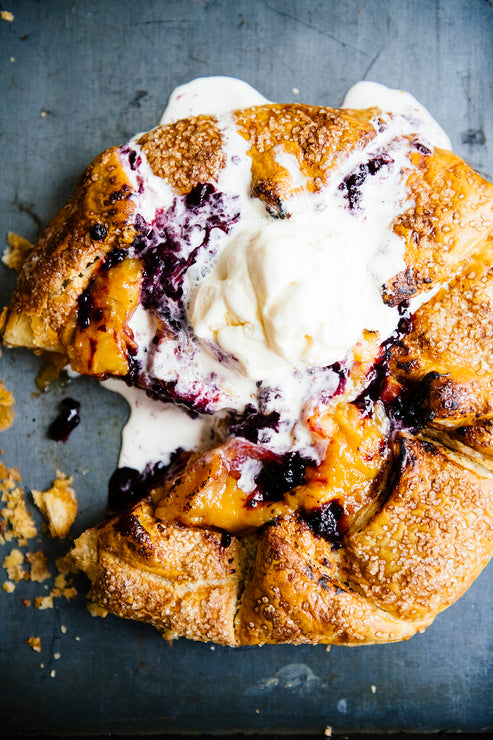 Load image into Gallery viewer, A homemade peach galette topped with Fruit Perfect Blackberries and vanilla ice cream
