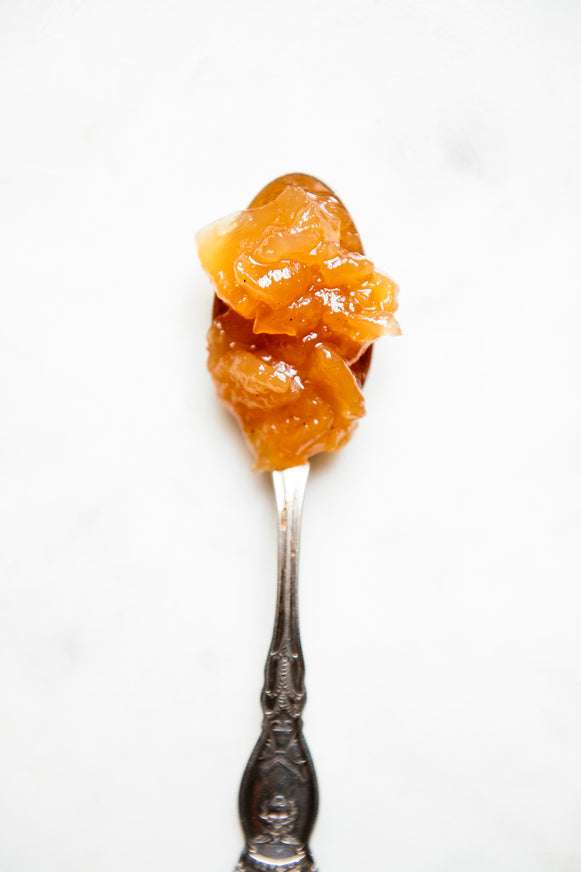 A spoon full of Red Haven Peach Preserves