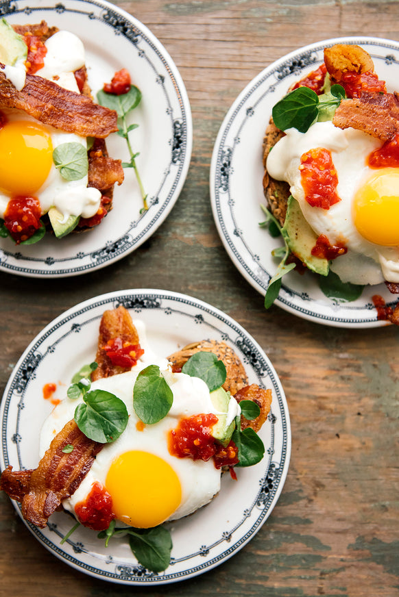 A breakfast sandwich topped with Chili Jam and avocado