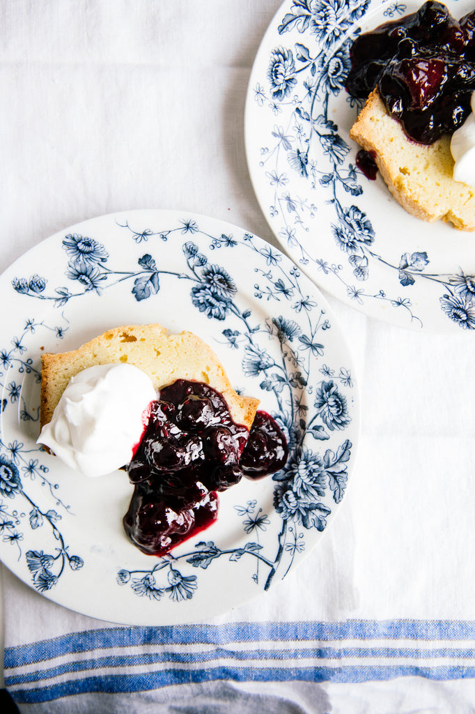 Plates of pound cake topped with Fruit Perfect Blueberries and homemade whipped cream
