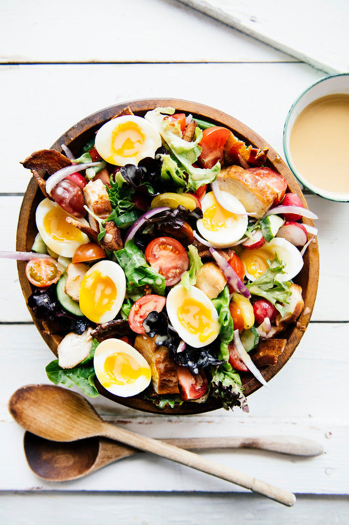 A cobb salad topped with Wildflower Honey Mustard vinaigrette