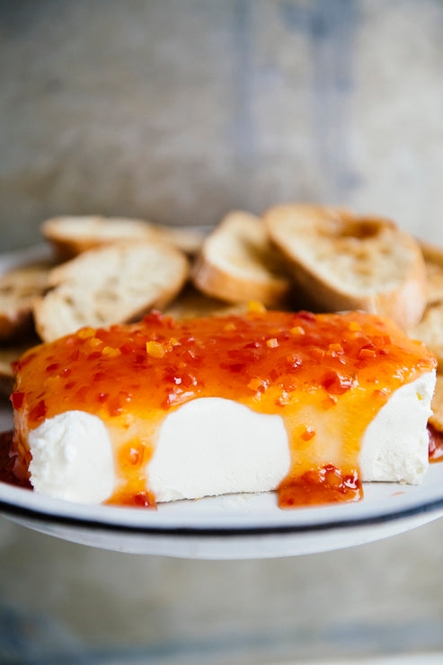 Load image into Gallery viewer, A block of cream cheese topped with Jalapeno Pepper Jelly
