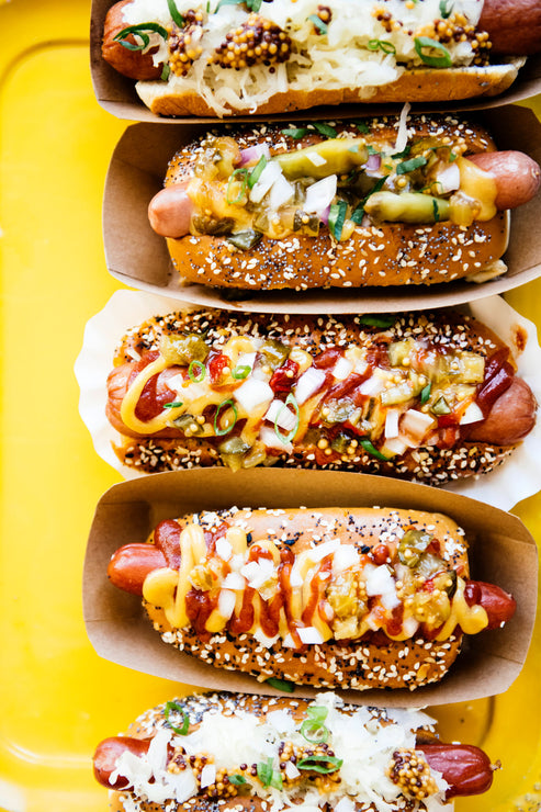 Load image into Gallery viewer, Hot Dogs topped with House Ketchup, Wholeseed Mustard, sauerkraut and onions