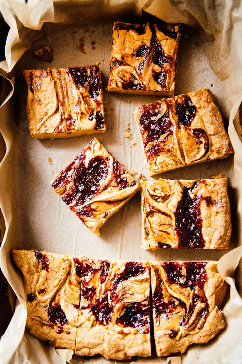 Load image into Gallery viewer, A tray of Peanut Butter and preserve blondies