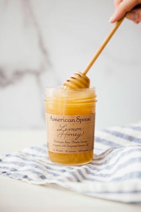 Load image into Gallery viewer, Open jar of Lemon Honey with a dipped Honey Dipper