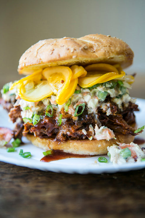 Load image into Gallery viewer, A pulled pork sandwich made with American Spoon Grilling Sauce and coleslaw