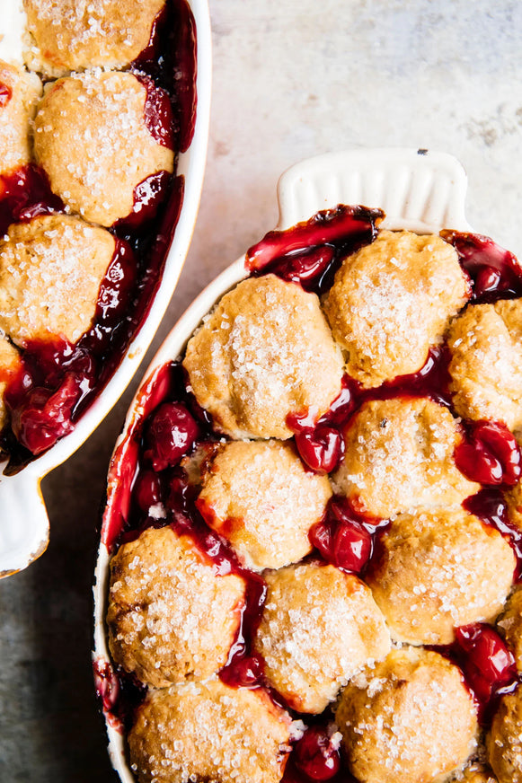 A cherry cobbler with sour cherries, biscuits and a sugar topping