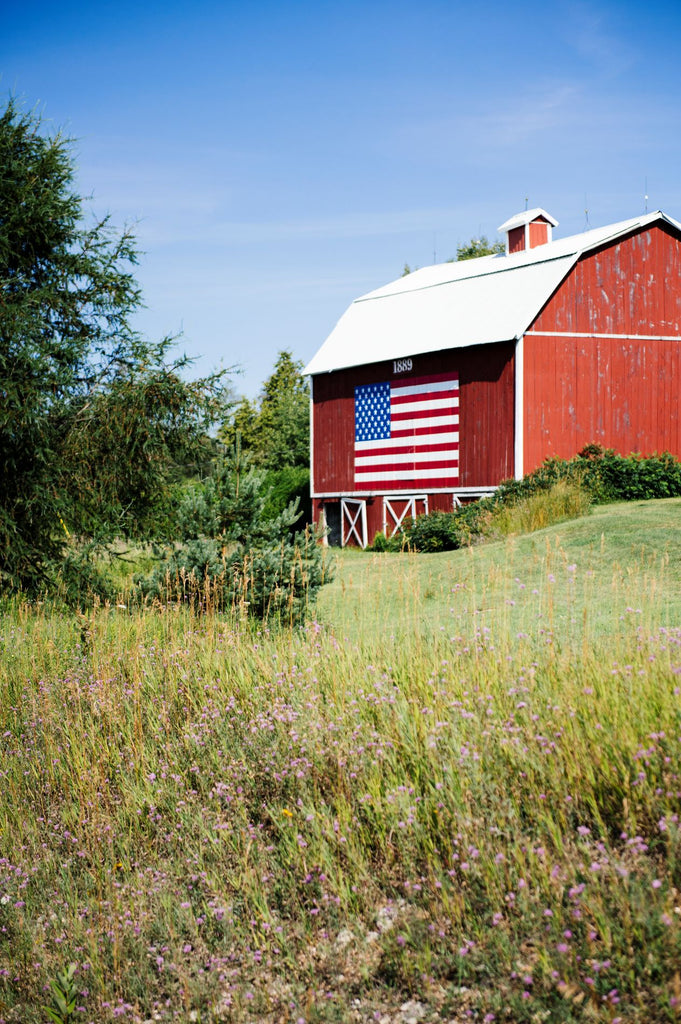 a red barn with an american flag painted on the side