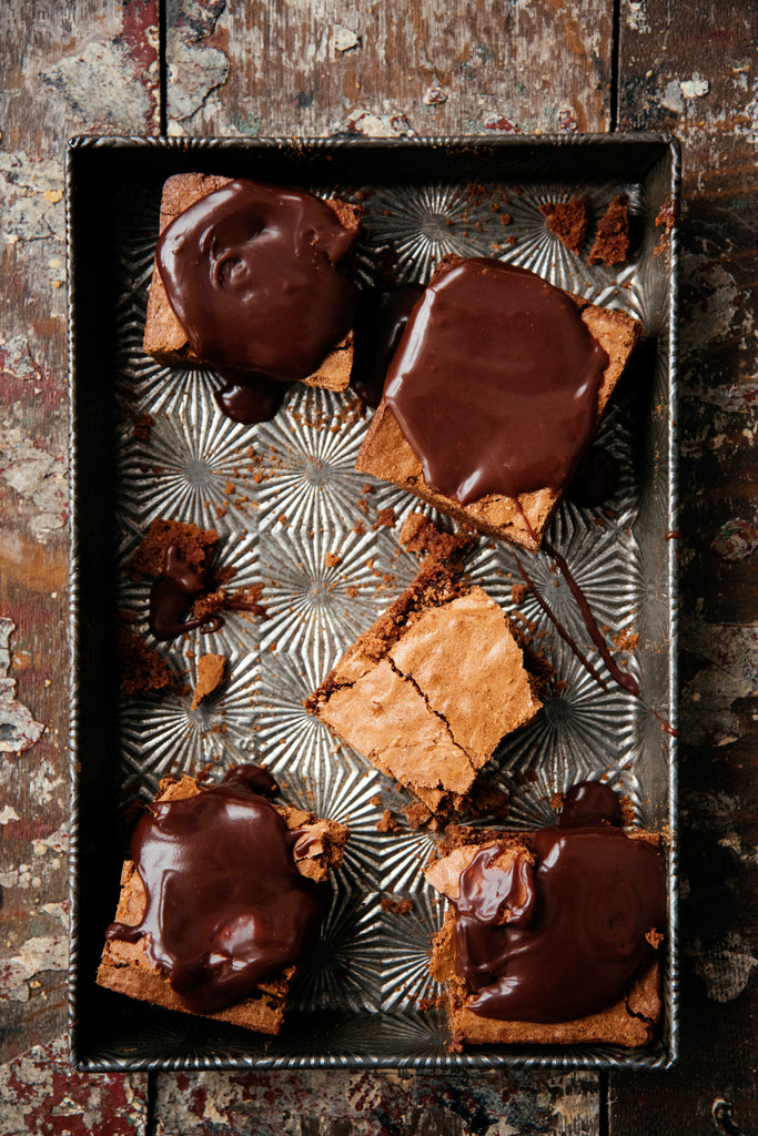 a pan of homemade brownies topped with fudge sauce