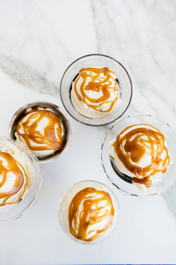 vintage bowls containing scoops of vanilla ice cream with butterscotch on top